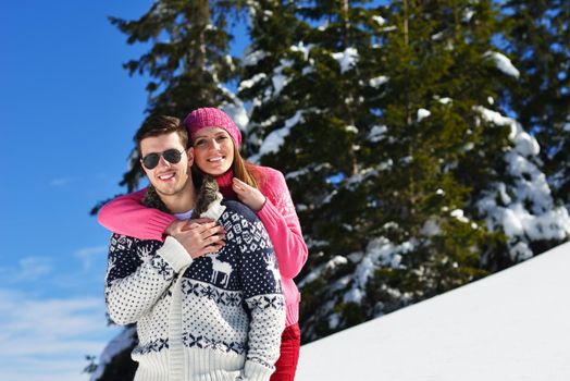 Young Couple In winter Snow Scene at  beautiful sunny day