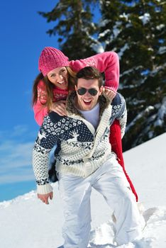 Young Couple In winter Snow Scene at  beautiful sunny day