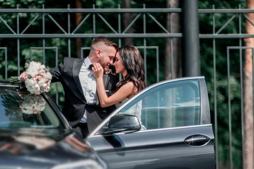 close up. bride and groom standing near the car. holidays and events