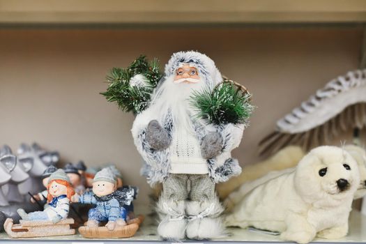 Santa claus with gifts on the shop counter with toys