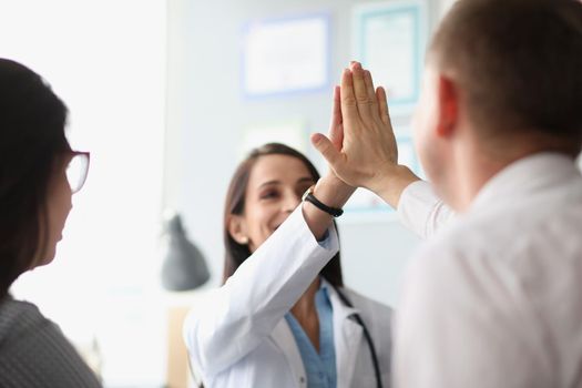 Portrait of colleagues give high five after successful agreement with partners. Happy coworker celebrating deal in office. Growth, business, career concept