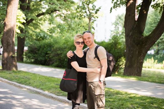 Portrait of a young beautiful happy couple on a sunny day in city park