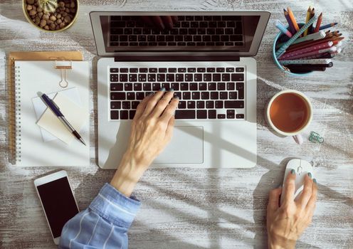 Work from home, online shopping, learning. Top view. Distance education. Woman hands typing on laptop. Freelancer, Digital nomad concept