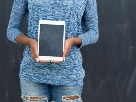 Young Happy African American Woman Using Digital Tablet  Isolated on a gray background