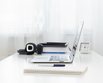 Freelance Desk with laptop. Distance education. Quarantine, self-isolation, sociophobia. Online learning, teleworking, online lectures. Concept of digital nomads, home office, blogging. No people.