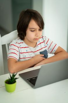 Child using laptop at home indoors. high quality photo