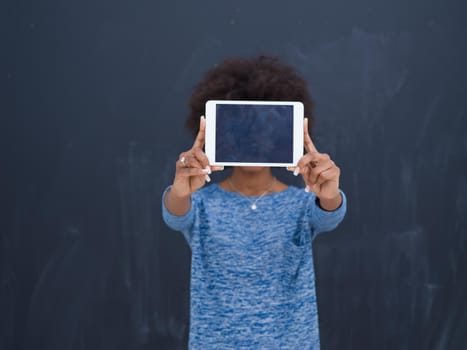 Young Happy African American Woman Using Digital Tablet  Isolated on a gray background