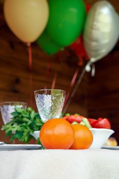 Table full of chopped vegetables and fruits colorful air balloons on wooden background countryside celebrations concept vertical