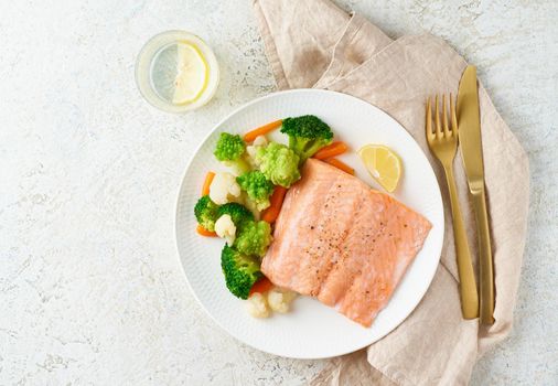 Steam salmon and vegetables, Paleo, keto, fodmap, dash diet. Mediterranean diet with steamed fish. Healthy concept, white plate on gray table, gluten free, lectine free, top view, copy space
