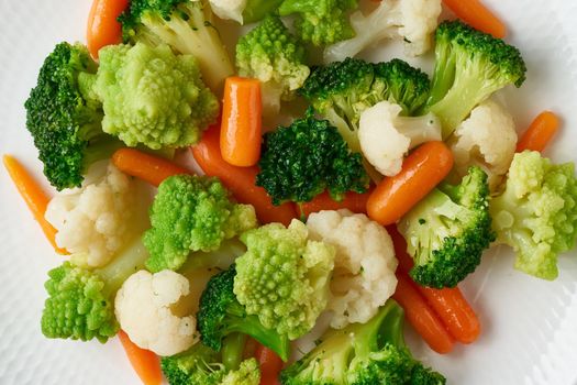Mix of boiled vegetables. Broccoli, carrots, cauliflower. Steamed vegetables for dietary low-calorie diet. FODMAP, dash diet, vegan, vegetarian, top view