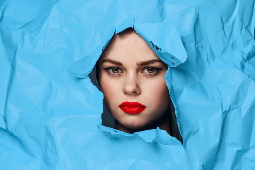female face blue background red lips makeup emotions. High quality photo