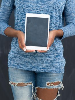 Young Happy African American Woman Using Digital Tablet  Isolated on a gray background