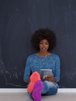 Young Happy African American Woman Using Digital Tablet  Isolated on a gray background