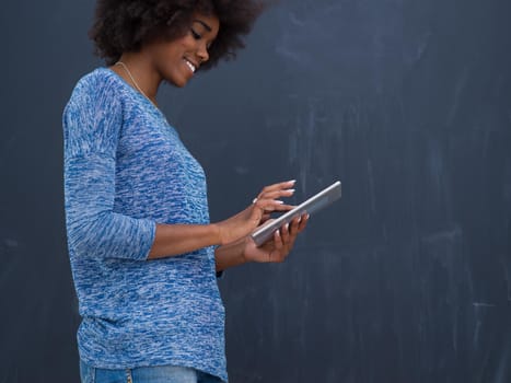 Young Happy African American Woman Using Digital Tablet  Isolated on a gray background