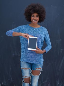 Young Happy African American Woman Using Digital Tablet  Isolated on a gray background