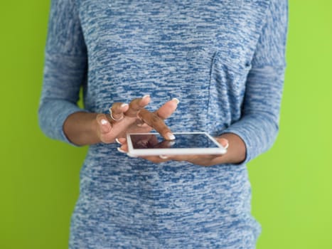 Young Happy African American Woman Using Digital Tablet  Isolated on a green background