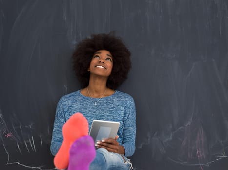 Young Happy African American Woman Using Digital Tablet  Isolated on a gray background