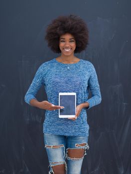 Young Happy African American Woman Using Digital Tablet  Isolated on a gray background