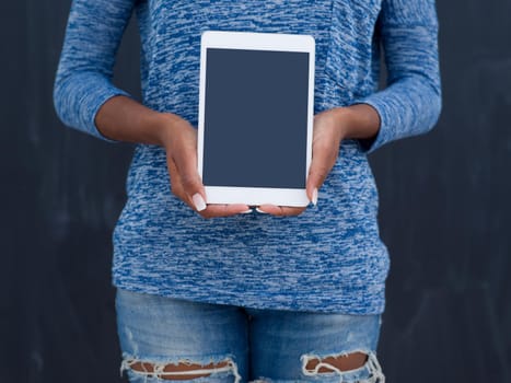 Young Happy African American Woman Using Digital Tablet  Isolated on a gray background