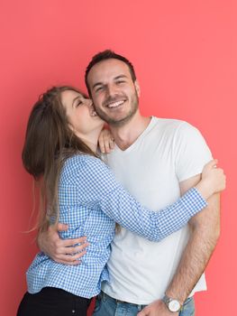 portrait of happy young loving couple looking at camera isolated on red Background
