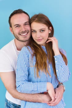 portrait of happy young loving couple looking at camera isolated on blue Background