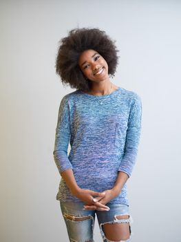 portrait of a beautiful friendly African American woman with a curly afro hairstyle and lovely smile isolated on a white background
