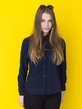 portrait of Beautiful young woman isolated on yellow background