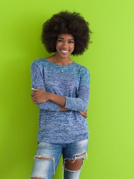 portrait of a beautiful friendly African American woman with a curly afro hairstyle and lovely smile isolated on a Green background