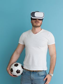 Happy man getting experience using VR headset glasses of virtual reality, isolated on blue background