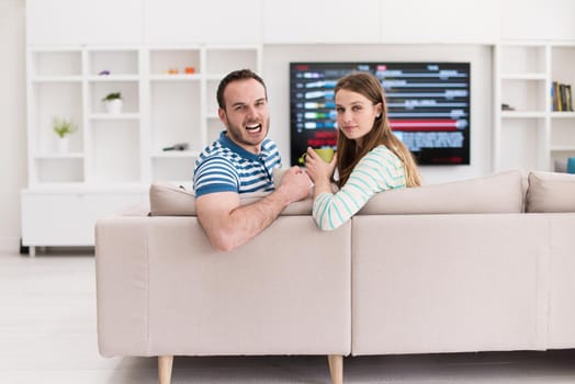 young beautiful handsome couple enjoying morning coffee at home