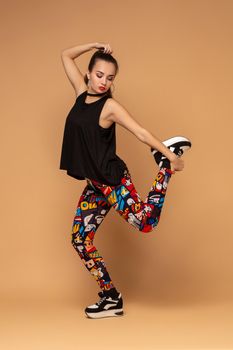 Modern style dancer posing on studio background. Dancer. Modern dance styles, dancehall, jazz funk, hip hop