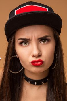 Close up positive portrait of pretty girl with amazing long brunette hair, bright sportive hat, bright make up, crazy funny face. Hip hop, jazz funk, dancehall