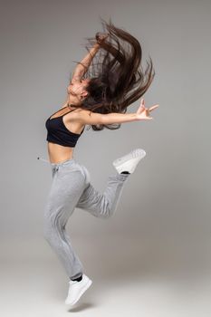 Modern style dancer posing on studio background. Dancing. Hobby. Hip hop, jazz funk, dancehall