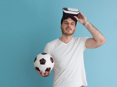 Happy man getting experience using VR headset glasses of virtual reality, isolated on blue background