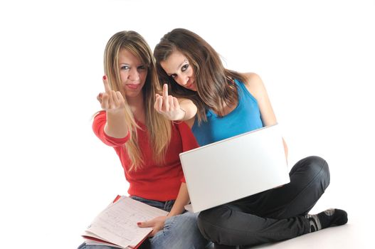 two young woman student work on laptop isolated and showing middle finger fuck off symbol