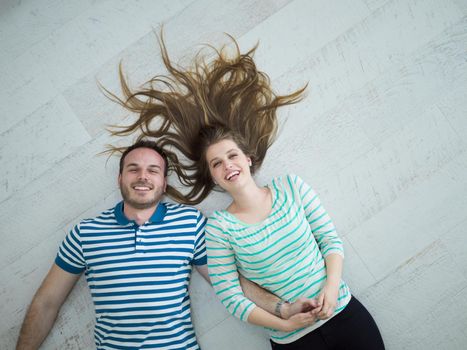 top view of handsome couple lying on floor