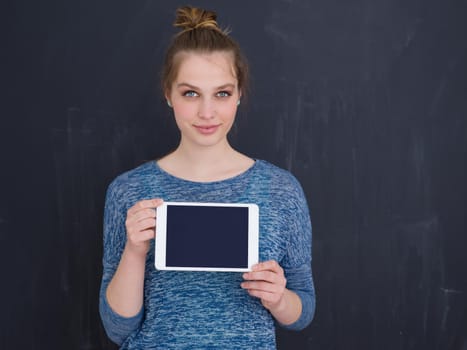Happy young woman using tablet computer isolated over gray background