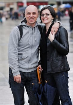 happy young couple together in fashionable clothing on street