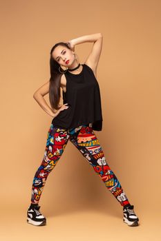 Modern style dancer posing on studio background. Dancer. Modern dance styles, dancehall, jazz funk, hip hop