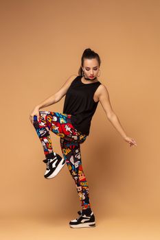 Modern style dancer posing on studio background. Dancer. Modern dance styles, dancehall, jazz funk, hip hop