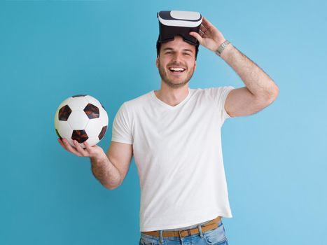 Happy man getting experience using VR headset glasses of virtual reality, isolated on blue background