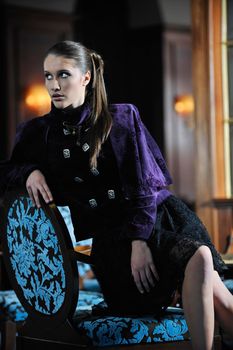 beautiful young woman lady in fashion dress posing in restaurant or bar at night
