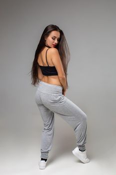 Modern style dancer posing on studio background. Dancing. Hobby. Hip hop, jazz funk, dancehall