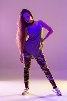 Modern style dancer posing on studio background. Dancing. Hobby. Hip hop, jazz funk, dancehall