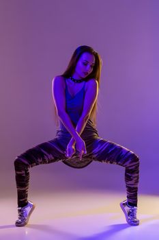 Modern style dancer posing on studio background. Dancer. Modern dance styles, dancehall, jazz funk, hip hop. Color filters