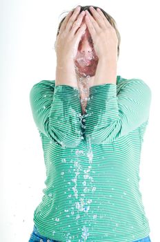 bautiful young woman wash face with clean water isolated on white in studio