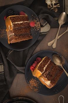 Delicious caramel cake slices with blackberries and raspberries.