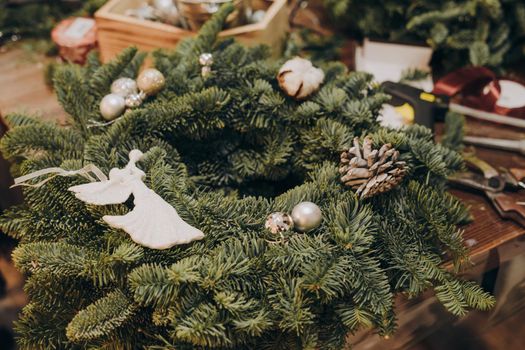 A master class on creating a Christmas wreath from a natural spruce with your own hands. A Christmas wreath made with your own hands. Christmas decorations, cotton, ribbons.