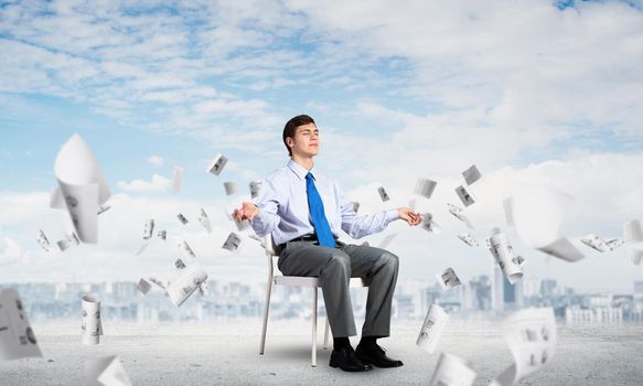 businessman sitting on an office chair, meditation and calmness