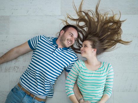 top view of handsome couple lying on floor